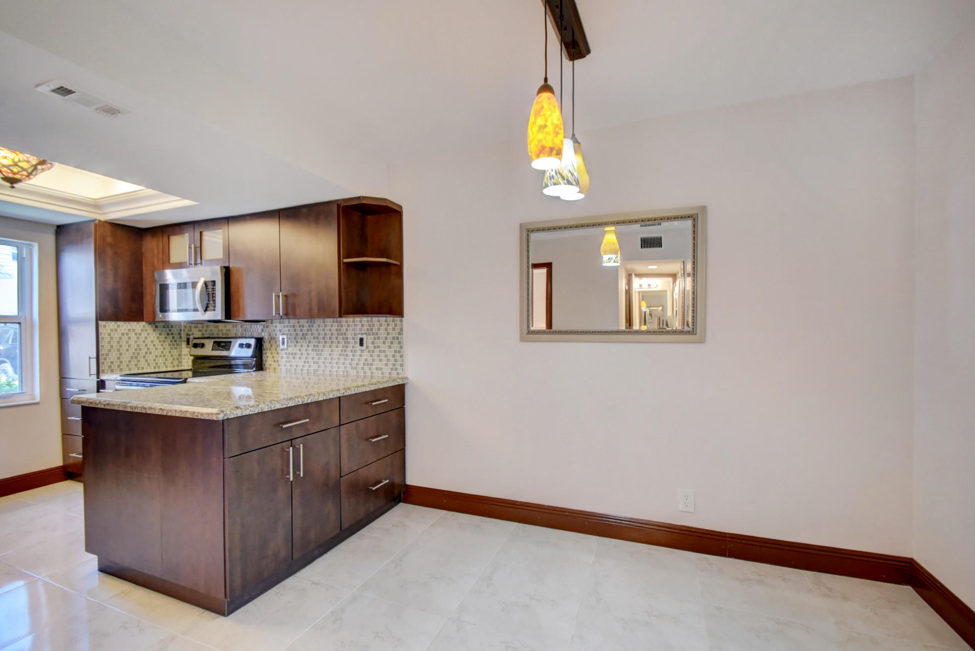1845 Northwest 4th Avenue, Unit 16 Boca Raton, FL 33432 - Photo 7 of 37 a bathroom with a sink a mirror and a toilet