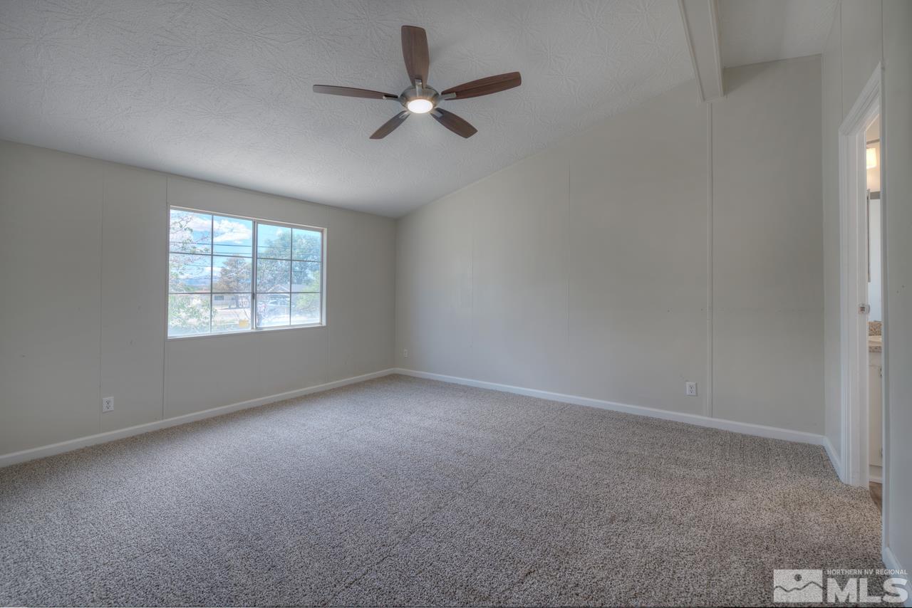 1380 Ricci Lane Fernley, NV 89408 - Photo 11 of 25 an empty room with a window and a fan
