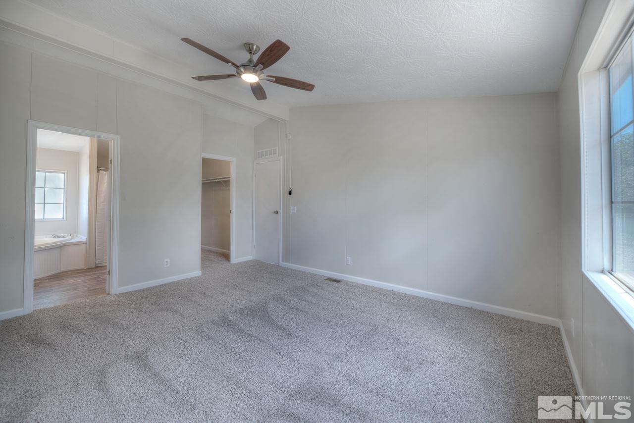1380 Ricci Lane Fernley, NV 89408 - Photo 12 of 25 an empty room with closet and windows
