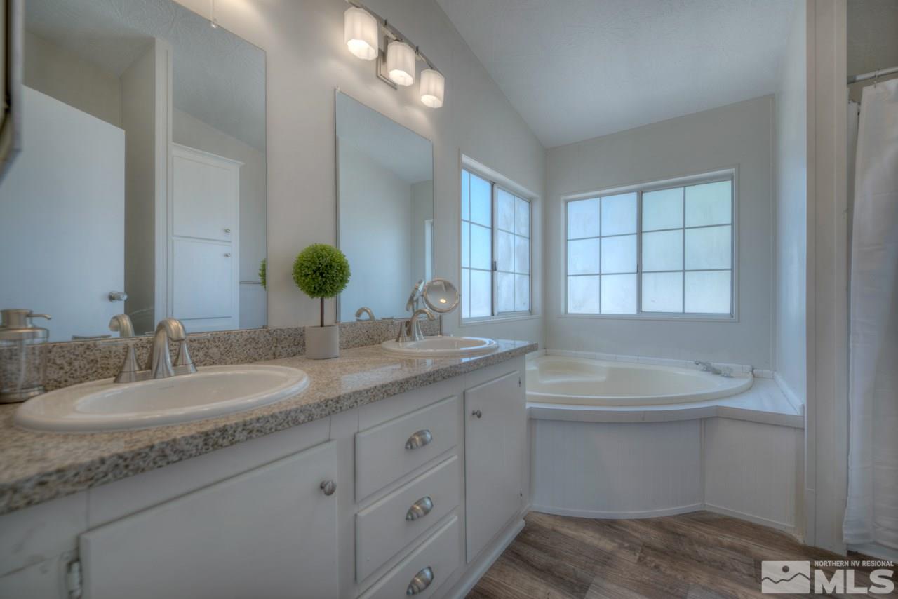 1380 Ricci Lane Fernley, NV 89408 - Photo 13 of 25 a bathroom with a granite countertop sink and a mirror