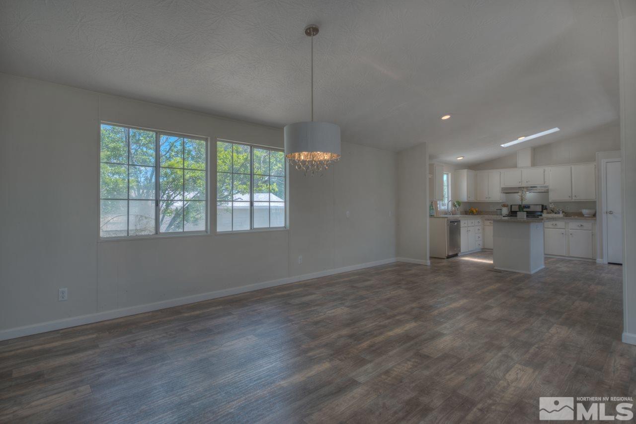 1380 Ricci Lane Fernley, NV 89408 - Photo 8 of 25 a view of a kitchen with a stove cabinets and a wooden floor