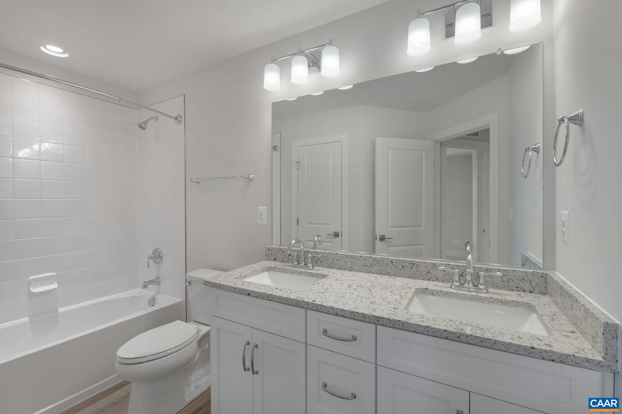 44 Marcella Street Charlottesville, VA 22911 - Photo 30 of 42 a bathroom with a granite countertop sink a toilet and a large mirror