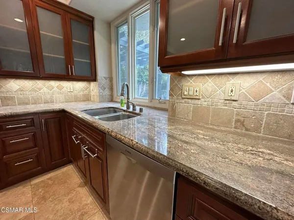 a sink with granite countertop a sink and cabinets