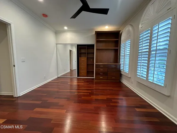 a bathroom with a granite countertop sink a toilet a mirror and bathtub