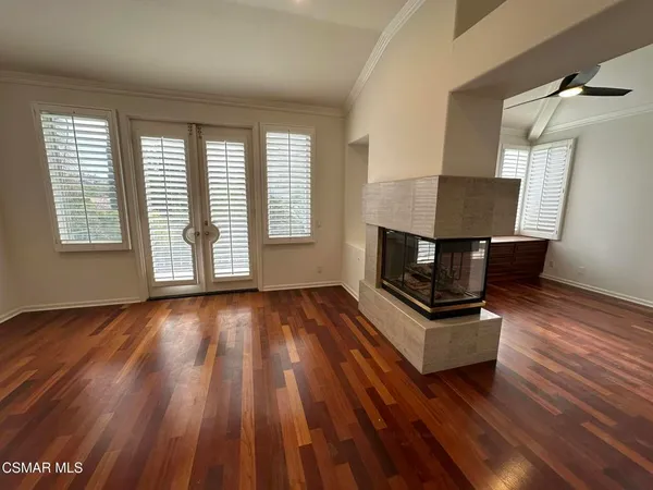 a room with wooden floors and window