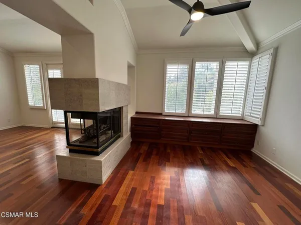 a view of an empty room and wooden floor
