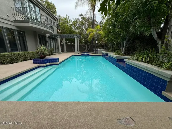 a view of swimming pool with a patio