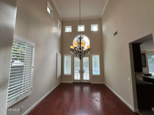 a view of a livingroom with a floor to ceiling window and wooden floor