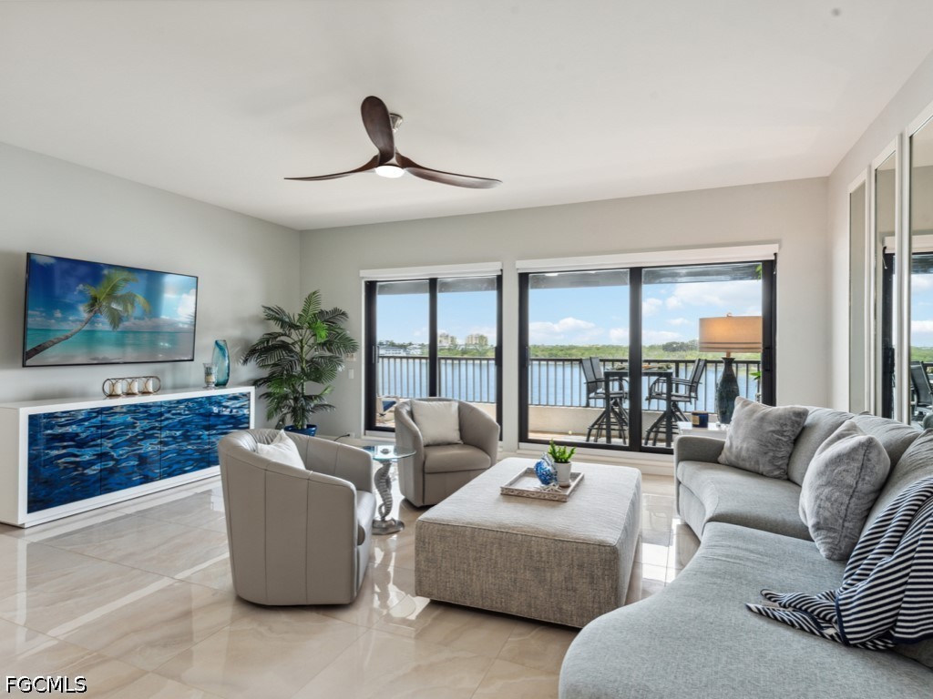 232 La Peninsula Boulevard, Unit 232 Naples, FL 34113 - Photo 12 of 44 a living room with furniture and a large window