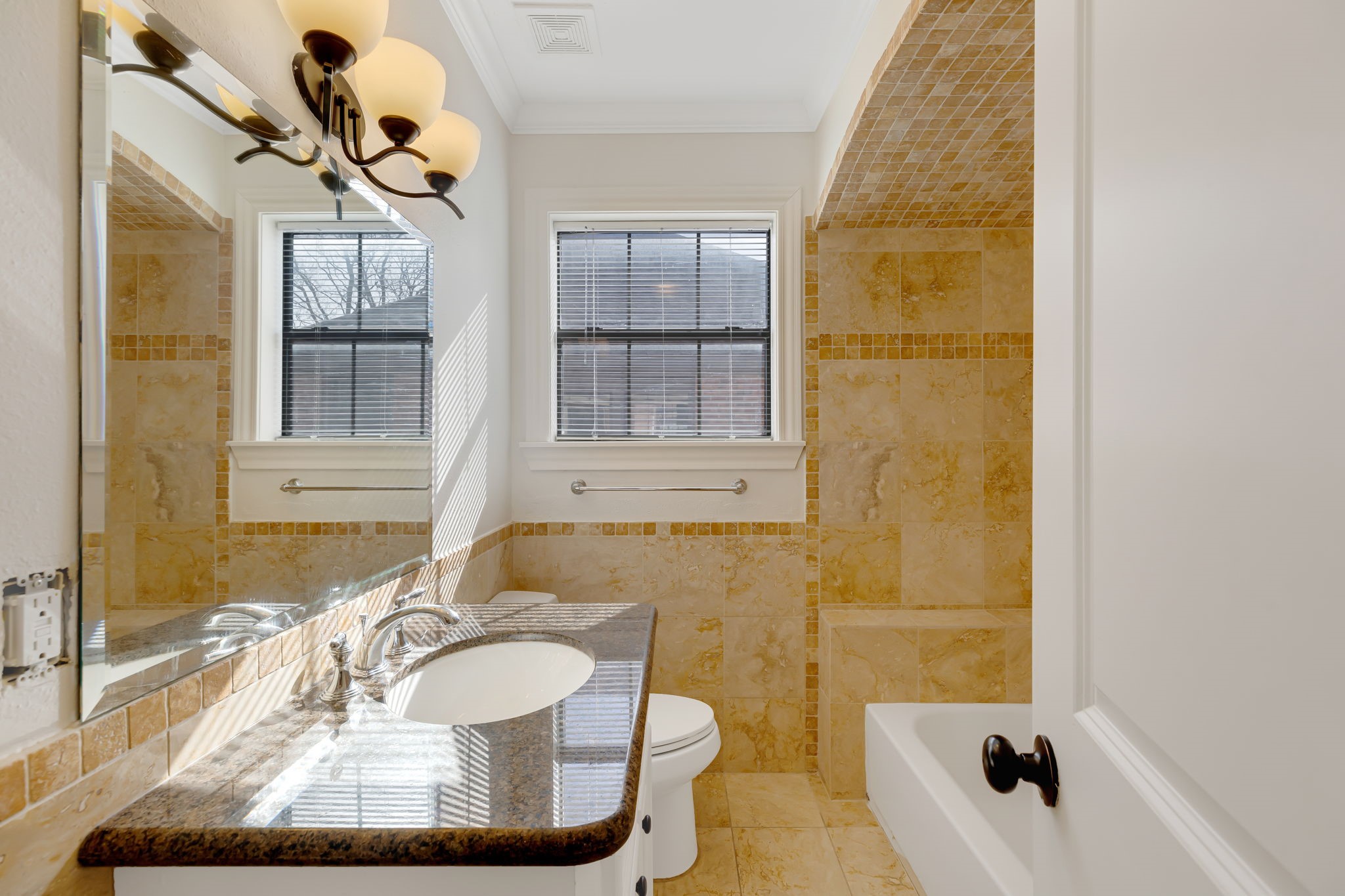 2306 Blodgett Street, Unit 2 Houston, TX 77004 - Photo 8 of 12 a bathroom with a sink and mirror with bathtub