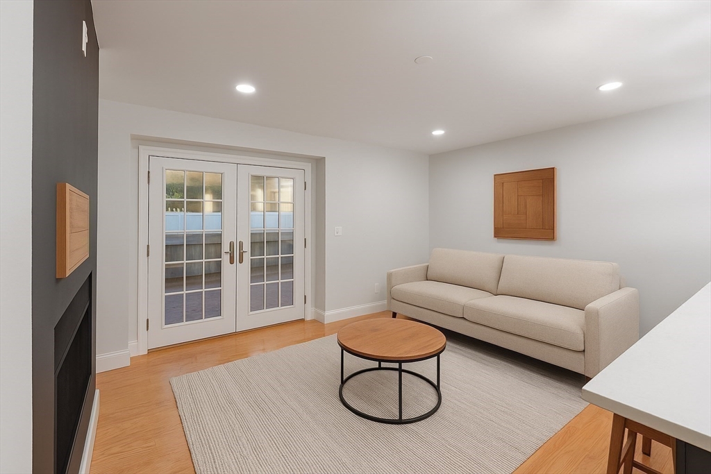 142 Pleasant Street, Unit 2 Winthrop, MA 02152 - Photo 3 of 14 a living room with furniture a flat screen tv and a window