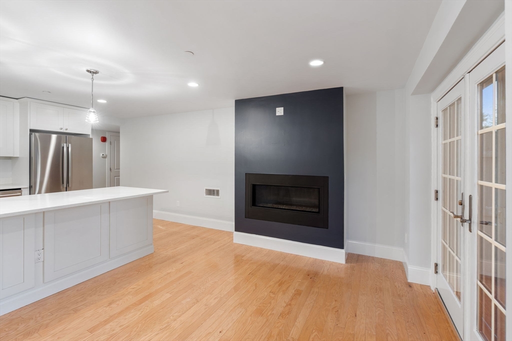 142 Pleasant Street, Unit 2 Winthrop, MA 02152 - Photo 4 of 14 a view of a kitchen with a sink and a fireplace