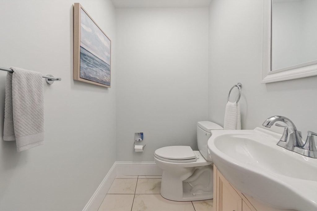 142 Pleasant Street, Unit 2 Winthrop, MA 02152 - Photo 7 of 14 a bathroom with a toilet sink and mirror