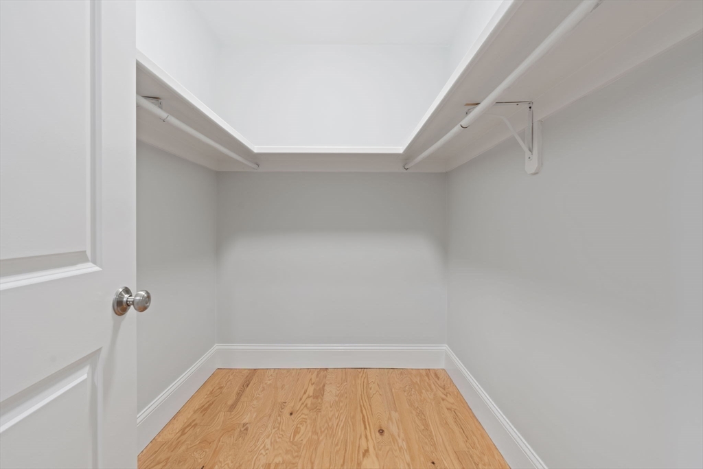 142 Pleasant Street, Unit 2 Winthrop, MA 02152 - Photo 10 of 14 a view of a room with racks on the wall