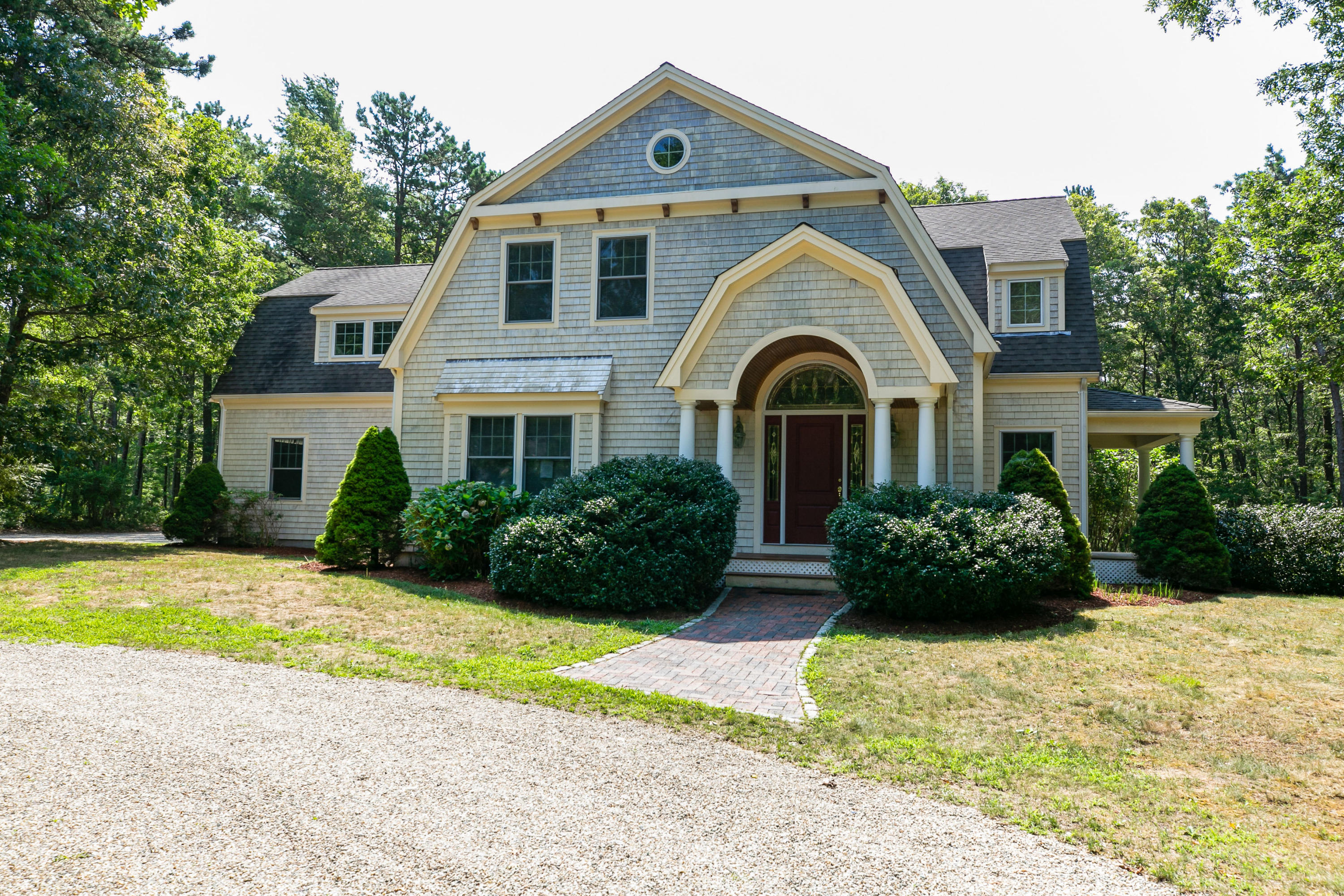 334 Waquoit Road Cotuit, MA 02635 - Photo 1 of 32 a front view of a house with a yard