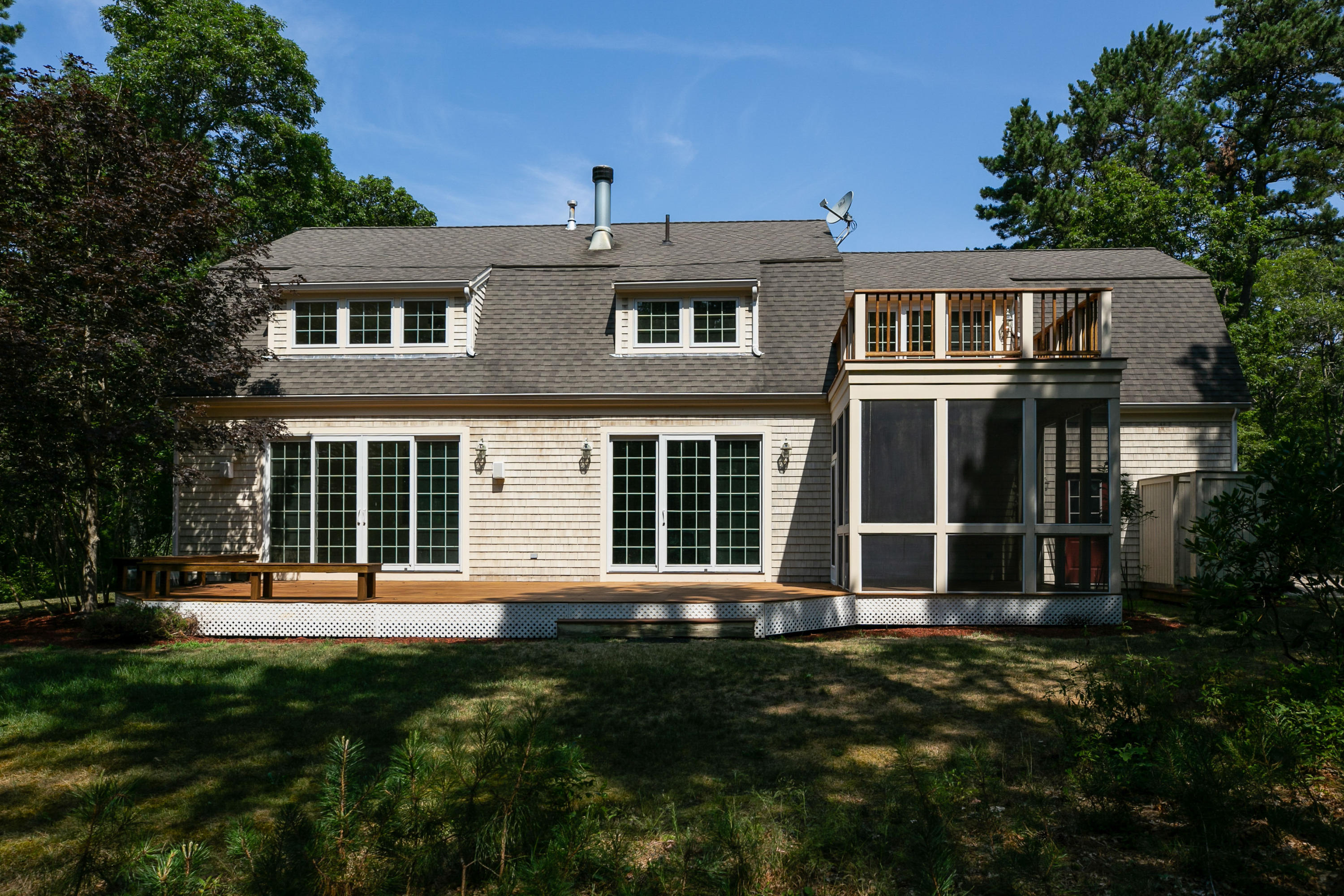 334 Waquoit Road Cotuit, MA 02635 - Photo 14 of 32 a front view of a house with a yard