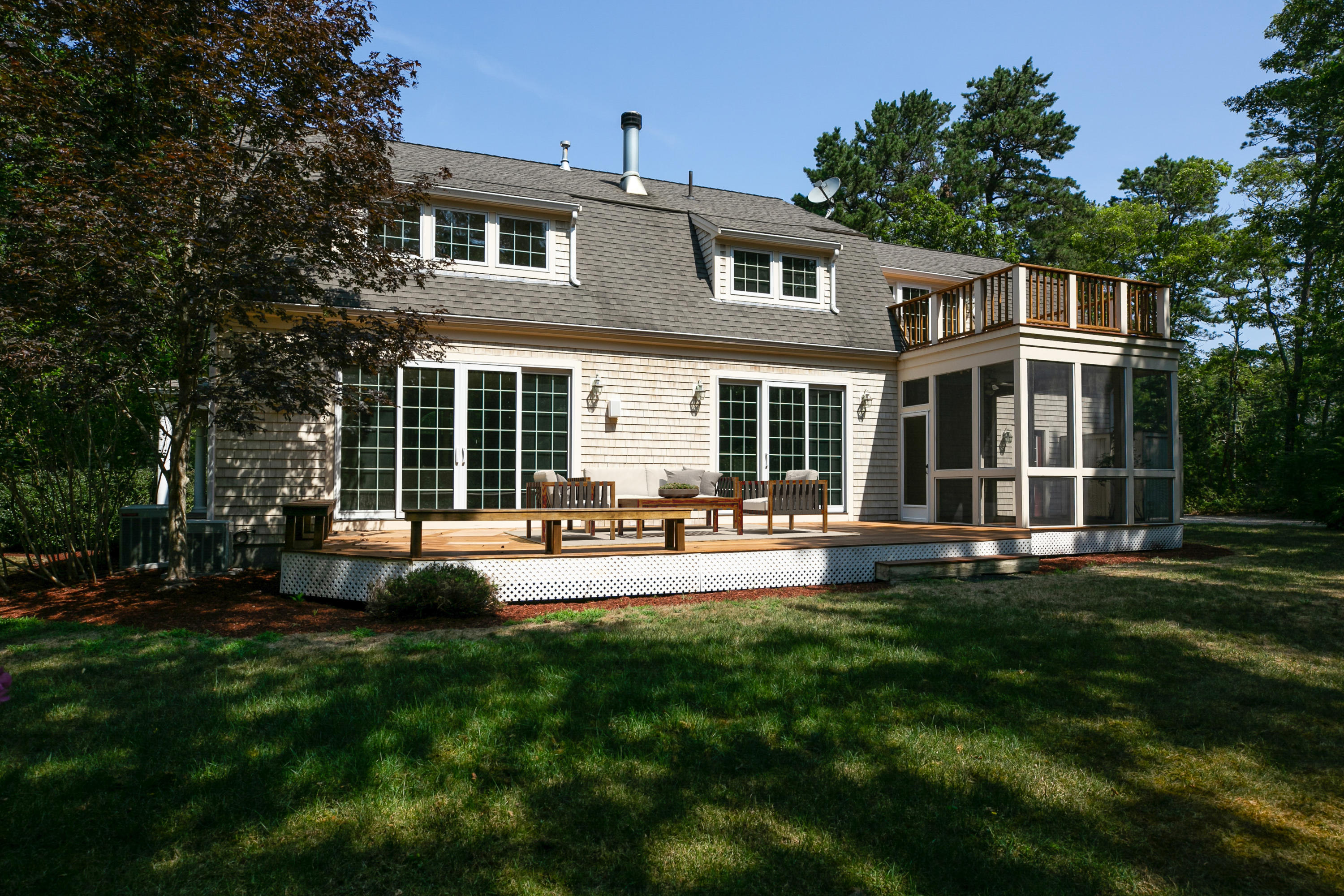 334 Waquoit Road Cotuit, MA 02635 - Photo 15 of 32 a front view of a house with swimming pool having outdoor seating