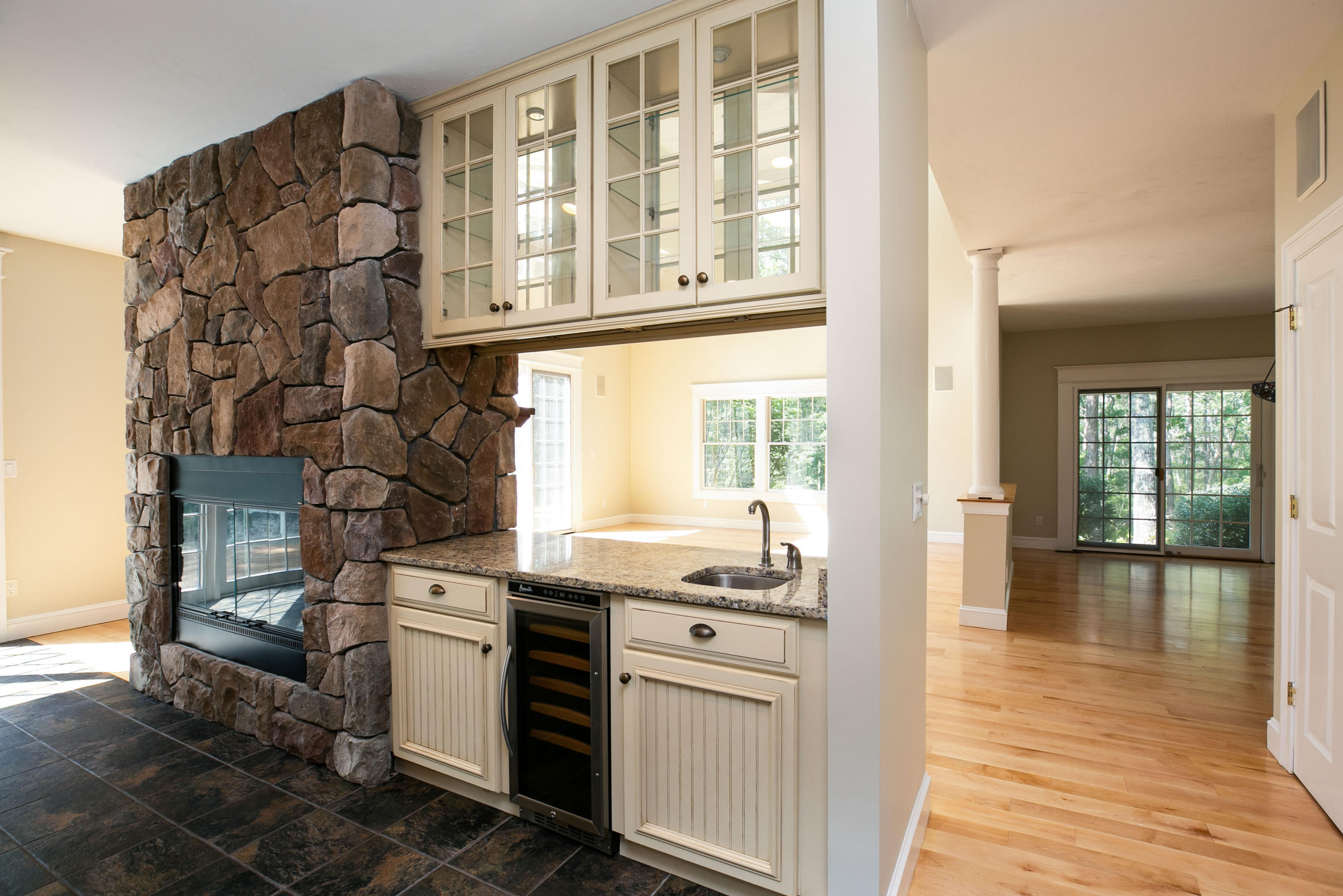 334 Waquoit Road Cotuit, MA 02635 - Photo 19 of 32 a kitchen with a stove and white cabinets with wooden floor