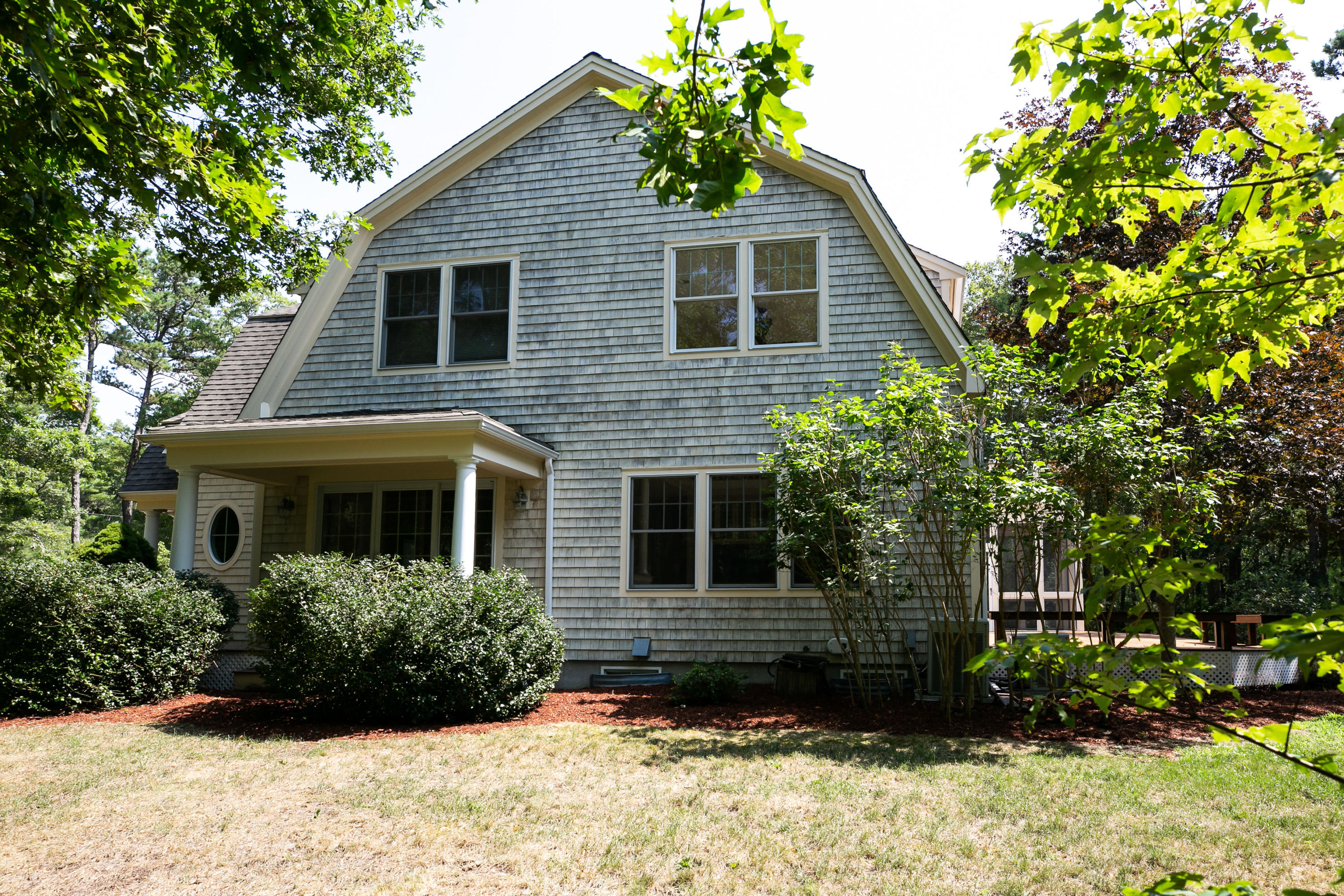 334 Waquoit Road Cotuit, MA 02635 - Photo 28 of 32 a view of a house with a yard