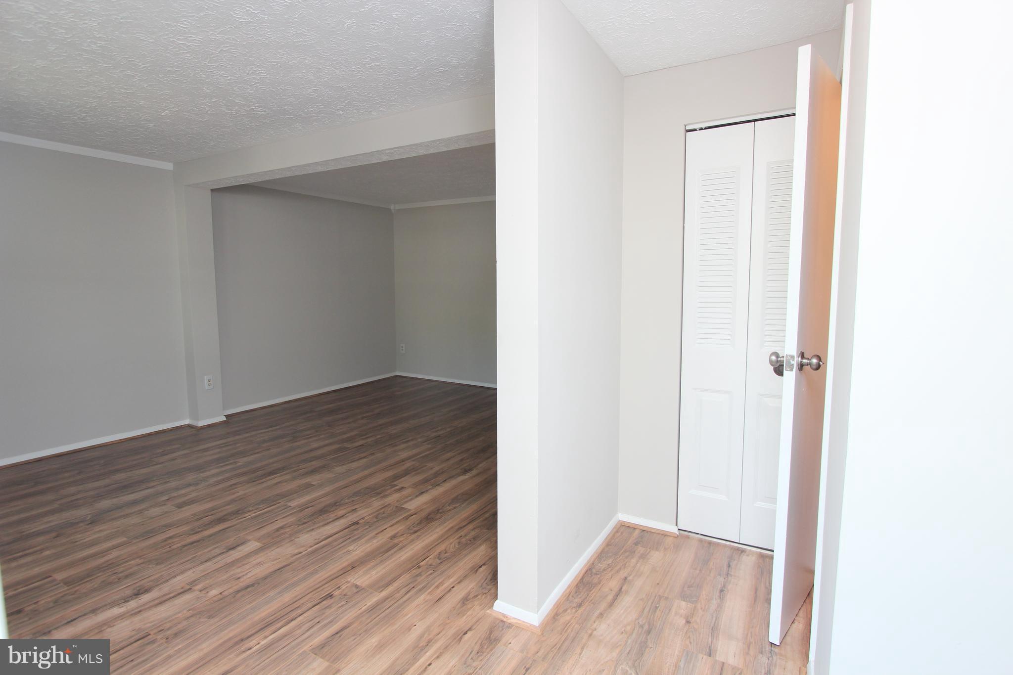 8757 Newington Commons Road Lorton, VA 22079 - Photo 2 of 20 a view of a hallway with wooden floor