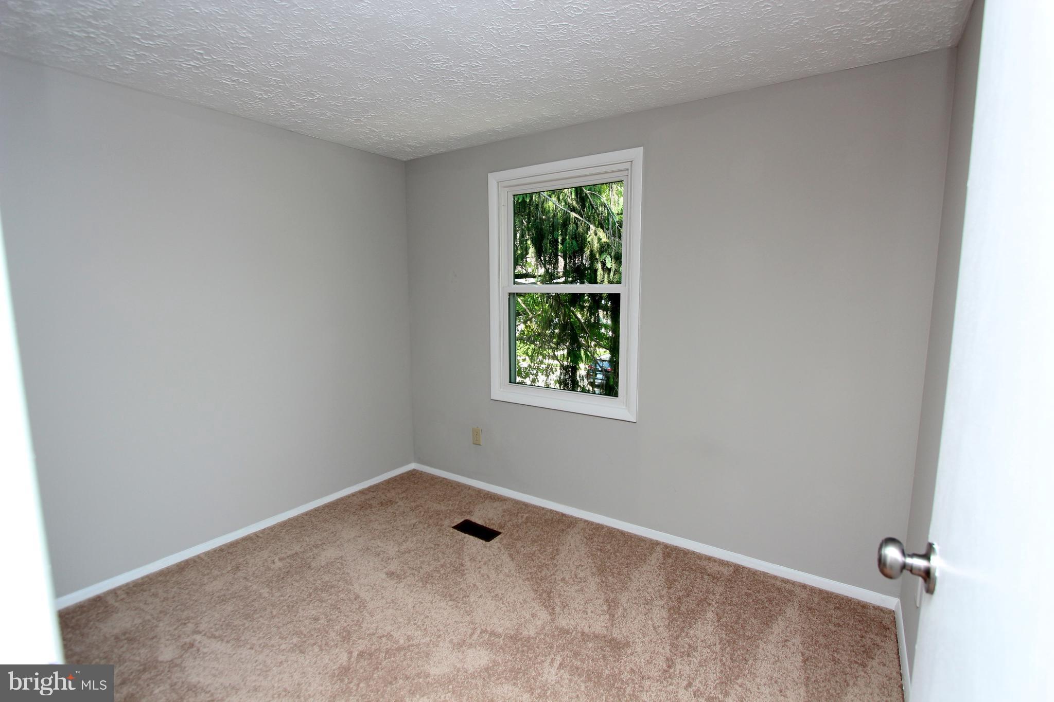 8757 Newington Commons Road Lorton, VA 22079 - Photo 13 of 20 an empty room with a window