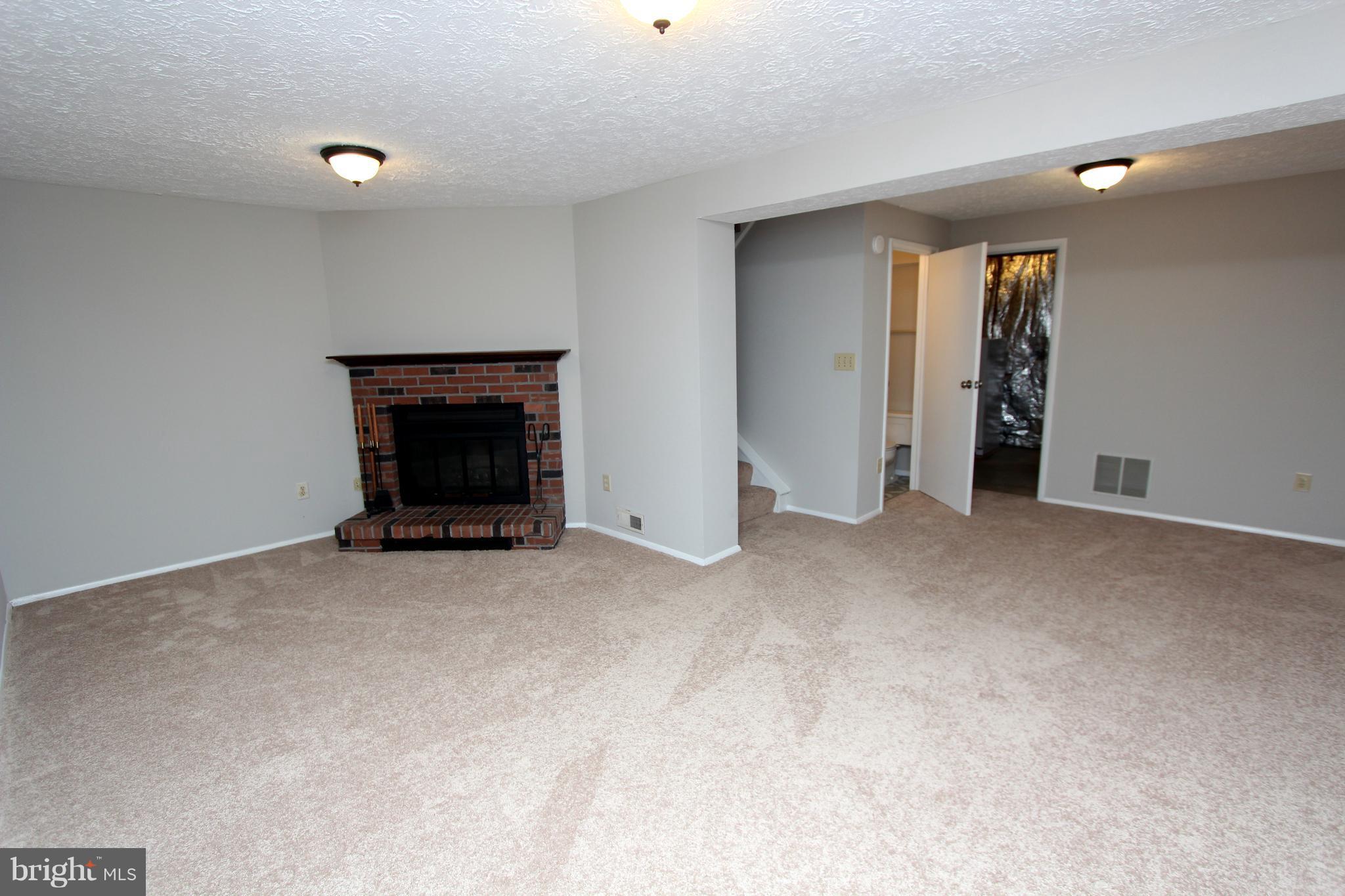 8757 Newington Commons Road Lorton, VA 22079 - Photo 16 of 20 a view of an empty room with window and fire place