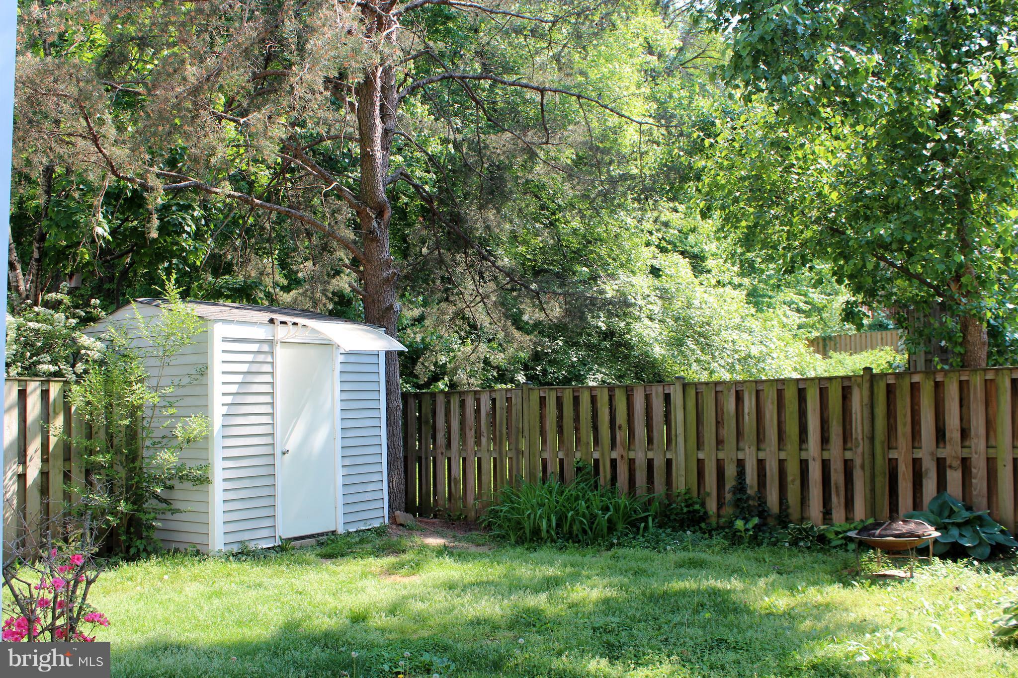 8757 Newington Commons Road Lorton, VA 22079 - Photo 20 of 20 a view of a backyard with plants and wooden fence