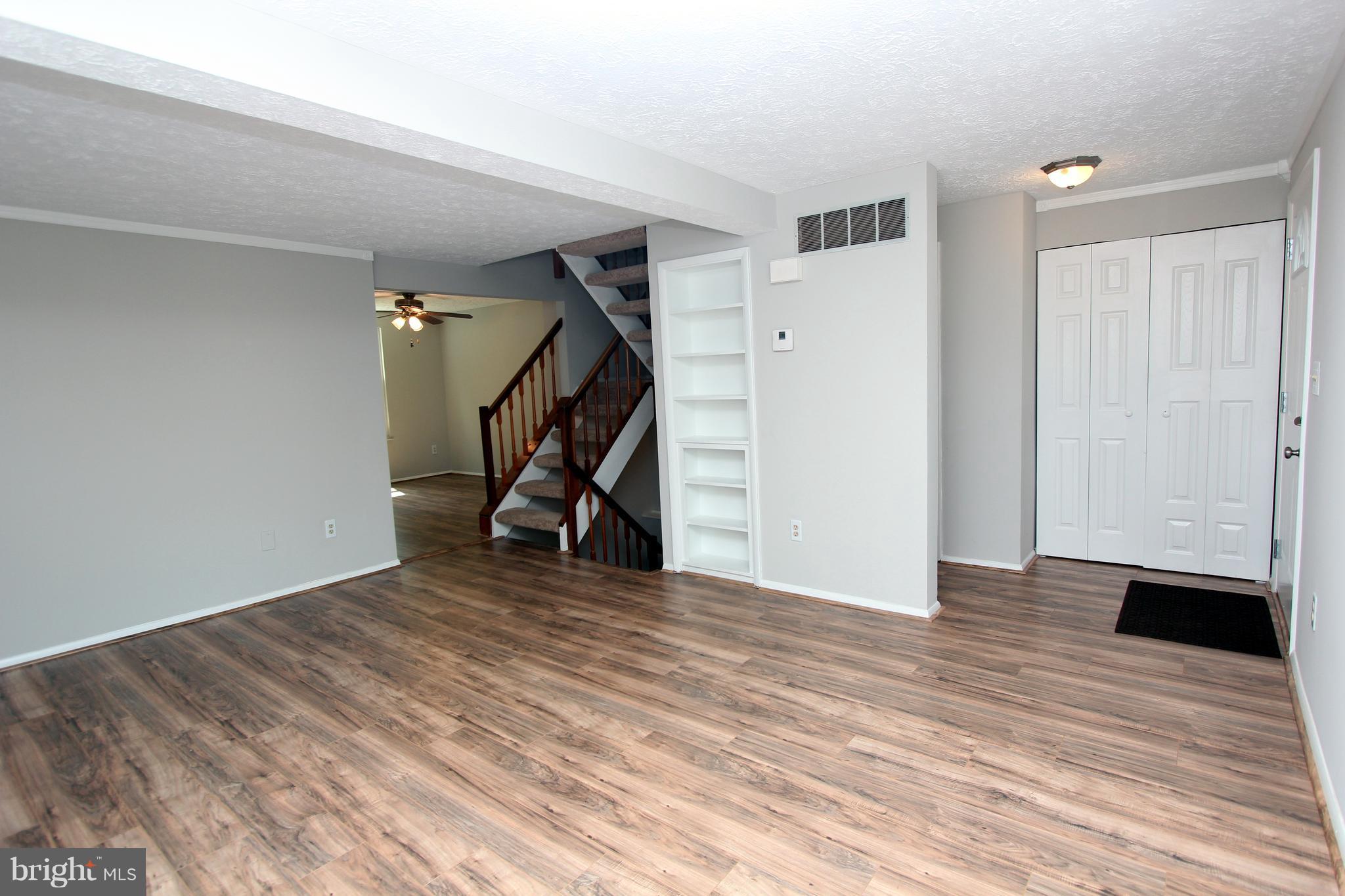 8757 Newington Commons Road Lorton, VA 22079 - Photo 3 of 20 a view of a room with wooden floor and stairs