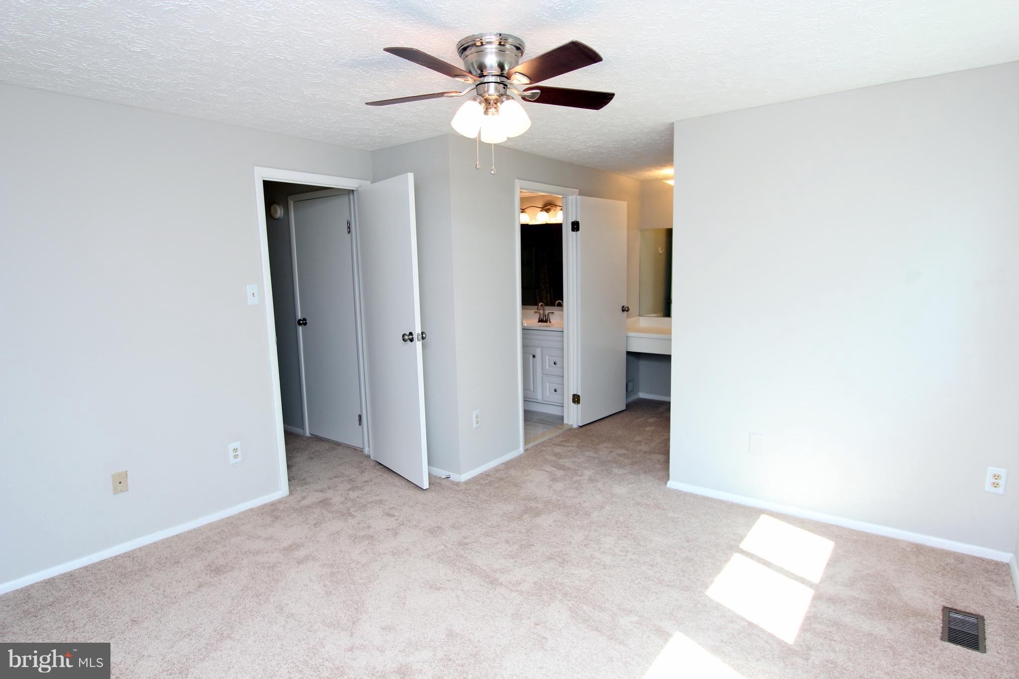 8757 Newington Commons Road Lorton, VA 22079 - Photo 9 of 20 a view of a room with a ceiling fan and a window