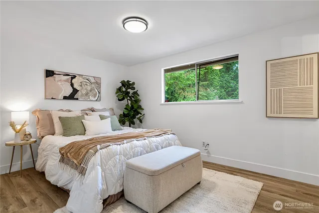 a bedroom with a large bed and a window