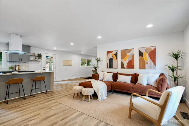 a living room with furniture and kitchen view