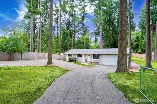 a view of a house with a yard and sitting area