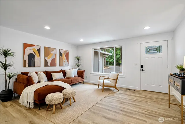 a living room with furniture and wooden floor