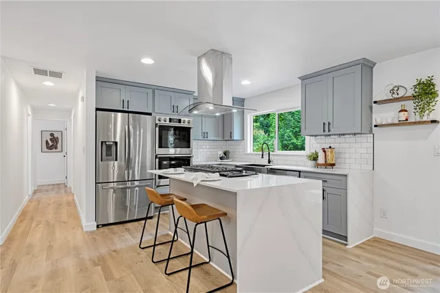 a kitchen with refrigerator a microwave and wooden floor