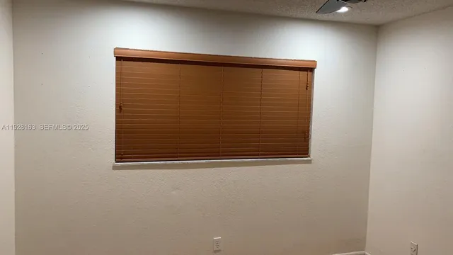 a view of a room wooden floor and a ceiling fan