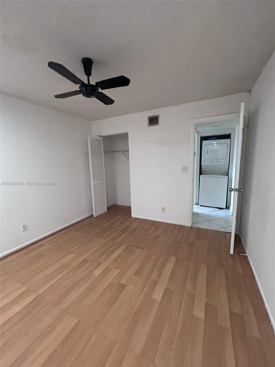 2997 Riverside Drive, Unit 212 Coral Springs, FL 33065 - Photo 14 of 18 a view of empty room with wooden floor and ceiling fan