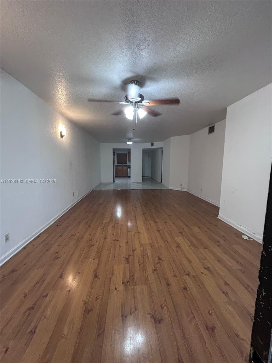 2997 Riverside Drive, Unit 212 Coral Springs, FL 33065 - Photo 15 of 18 a view of a room wooden floor and a ceiling fan