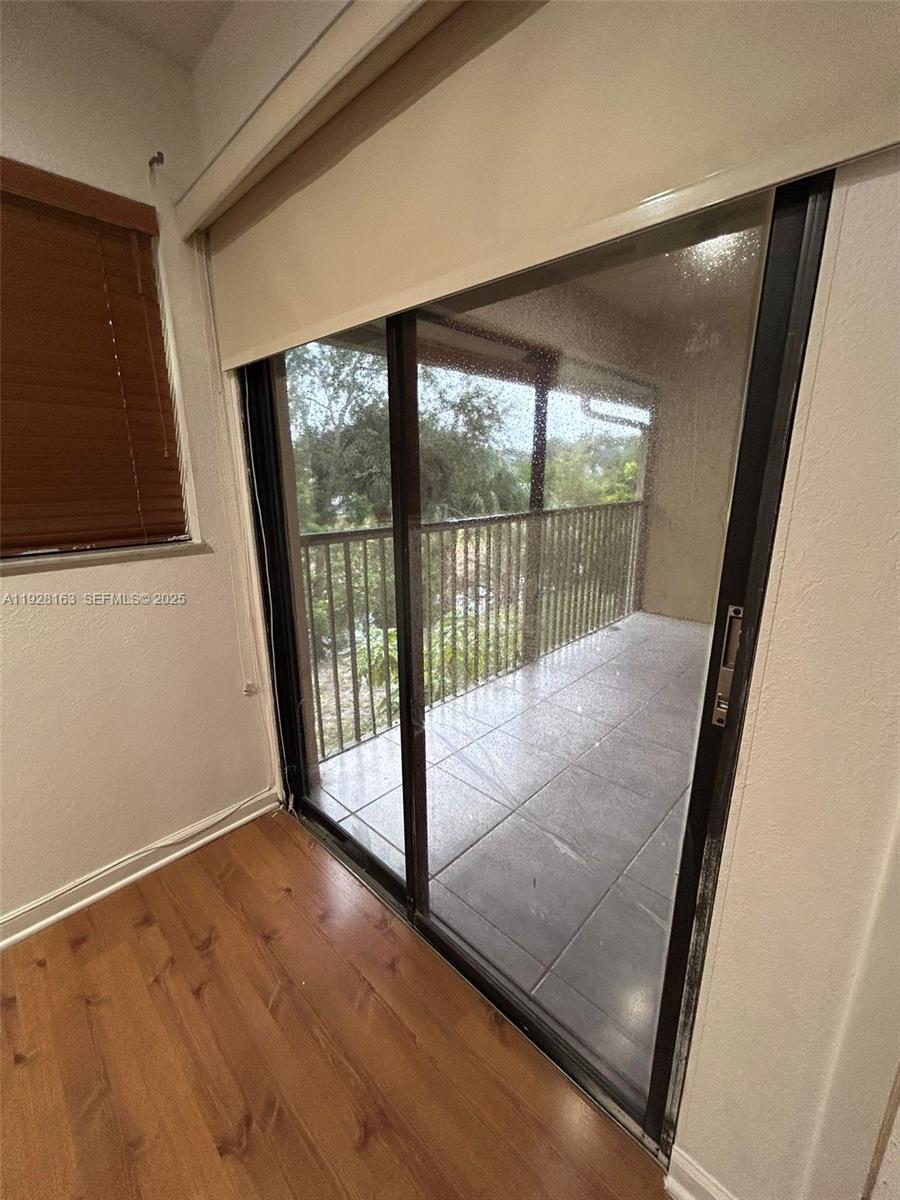 2997 Riverside Drive, Unit 212 Coral Springs, FL 33065 - Photo 16 of 18 a view of a room with wooden floor and windows