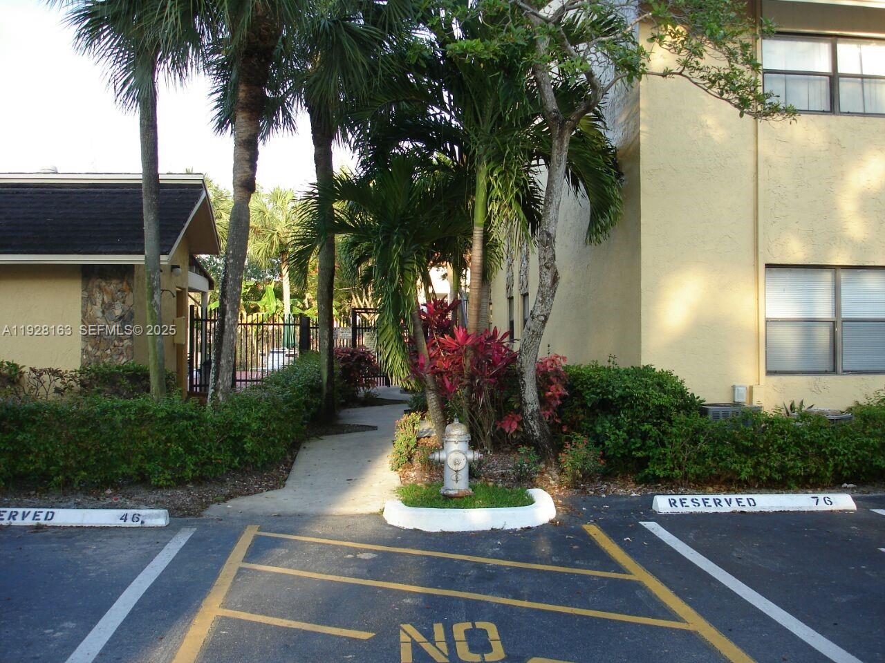 2997 Riverside Drive, Unit 212 Coral Springs, FL 33065 - Photo 5 of 18 a front view of a house with tree s