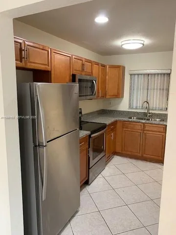 a kitchen with granite countertop a sink and cabinets