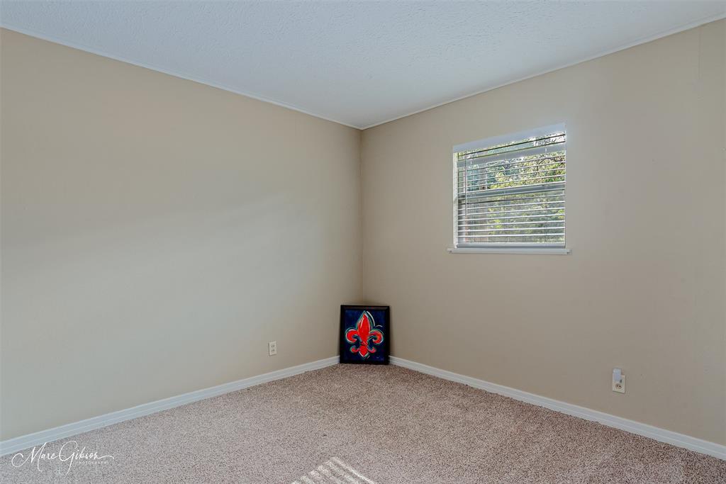 9342 Dean Road Shreveport, LA 71118 - Photo 13 of 18 Carpeted room featuring a single window with blinds, neutral wall paint, and white trim