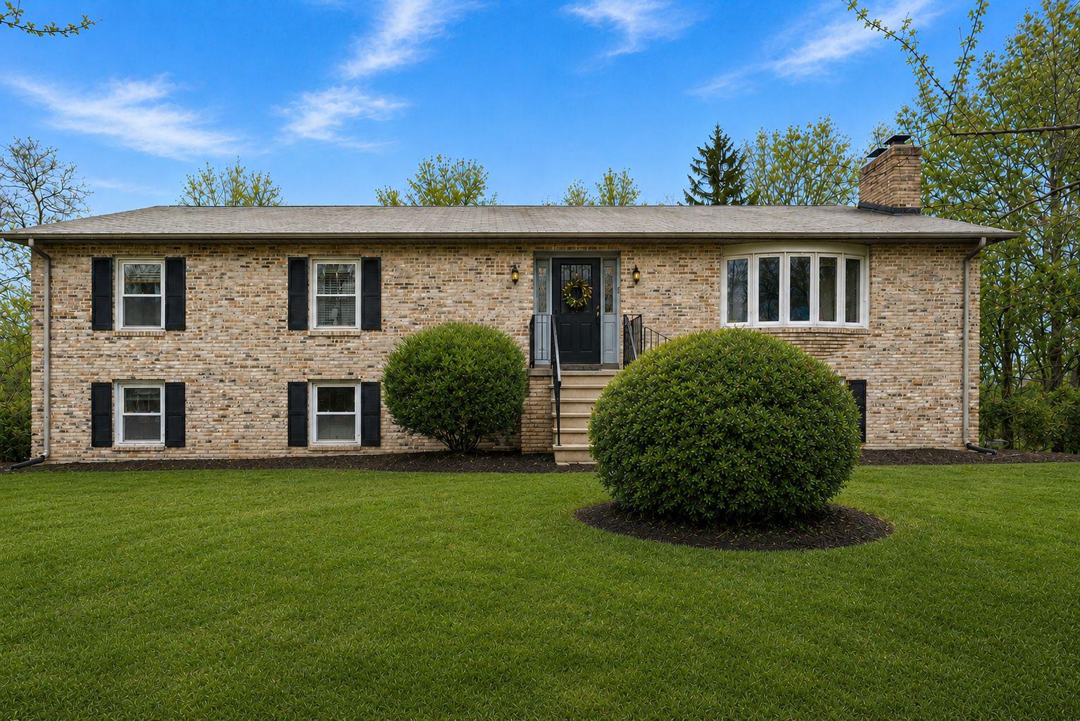 13100 Croom Road Upper Marlboro, MD 20772 - Photo 1 of 34 a front view of a house with a garden