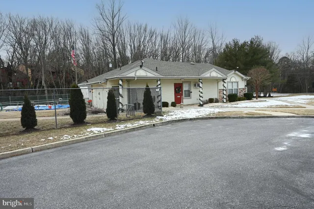 a view of a backyard with table and chairs and wooden fence