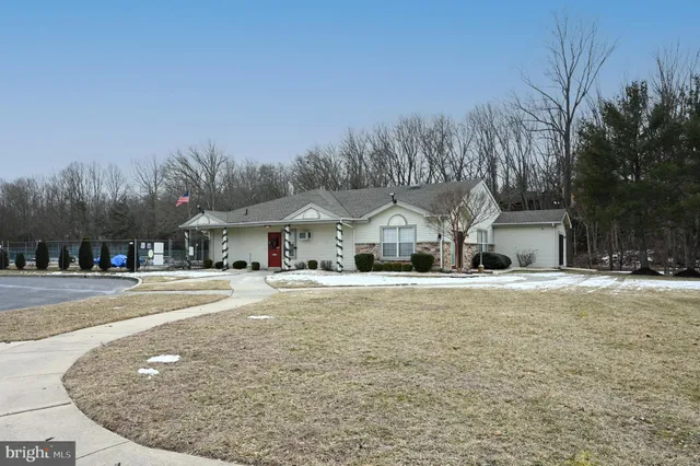 a living room with fireplace furniture and a wooden floor