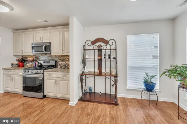 a large bed sitting in a bedroom next to a window