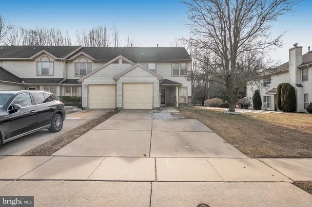 a view of a car park in front of house
