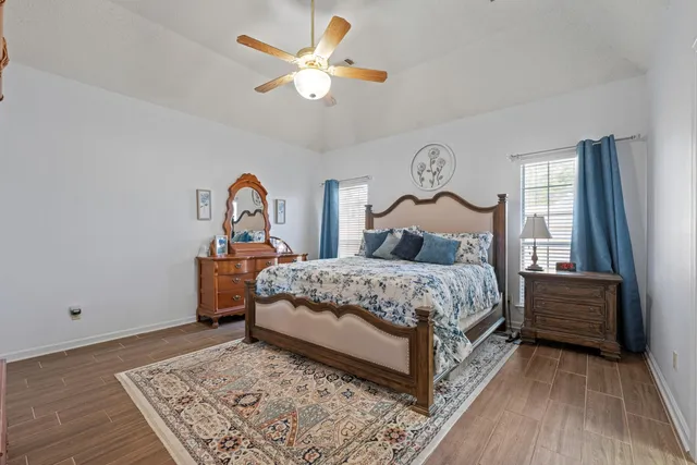 a bedroom with a bed and a chandelier