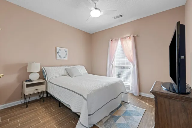 a bedroom with a bed and a flat screen tv