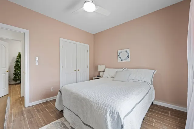 a bedroom with a bed and wooden floor