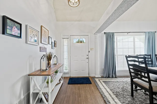 a view of a room with furniture and wooden floor